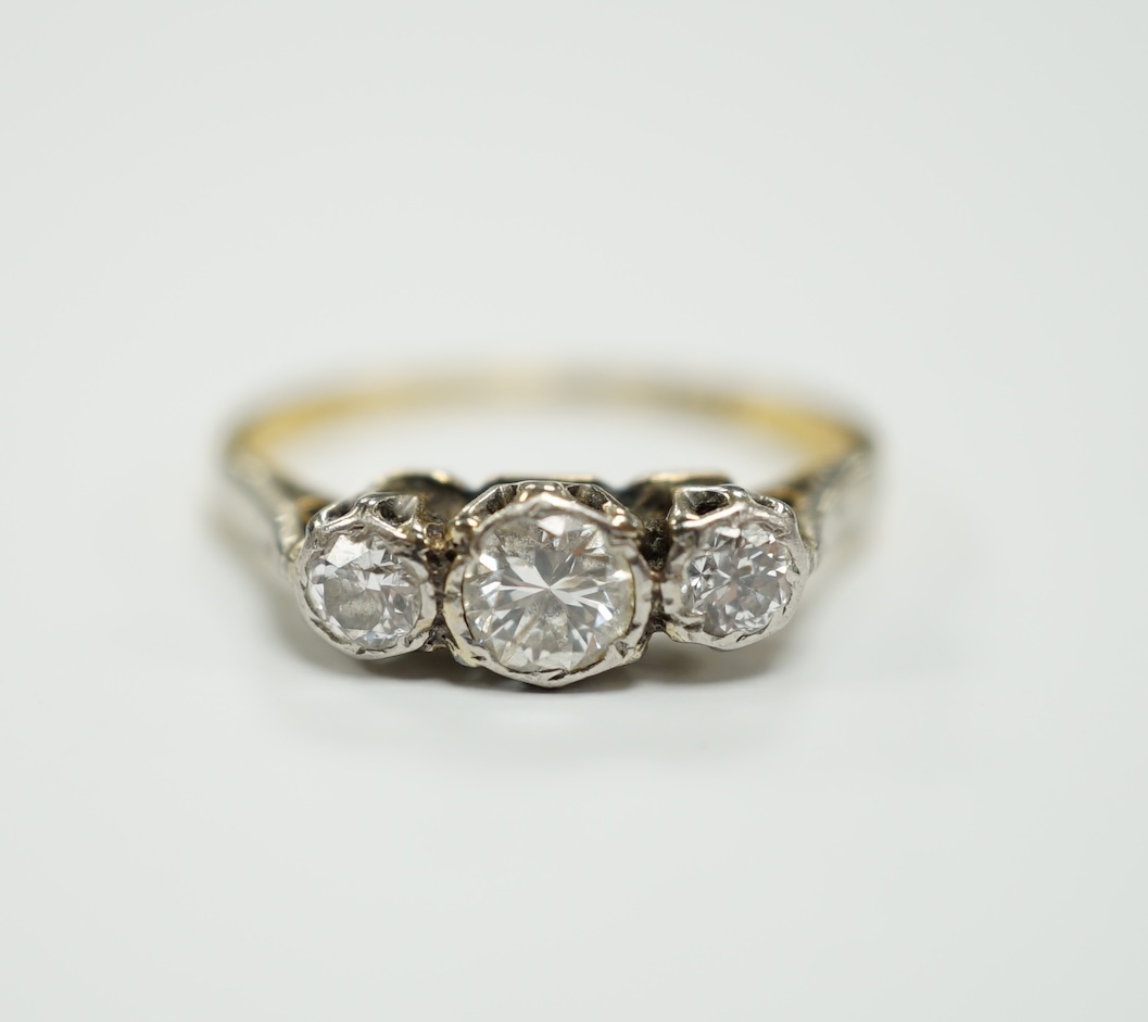 An 18ct and illusion set three stone diamond ring, size I, gross weight 2 grams.